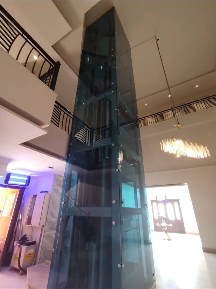 Panoramic glass elevator in a private residence