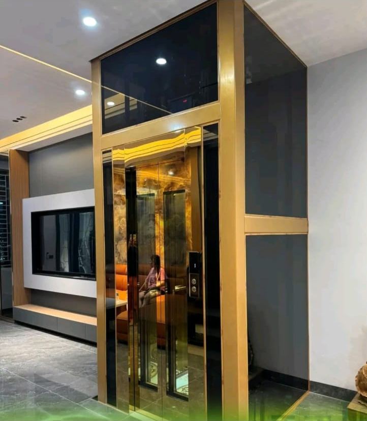 Gold-finish glass home elevator, villa installation